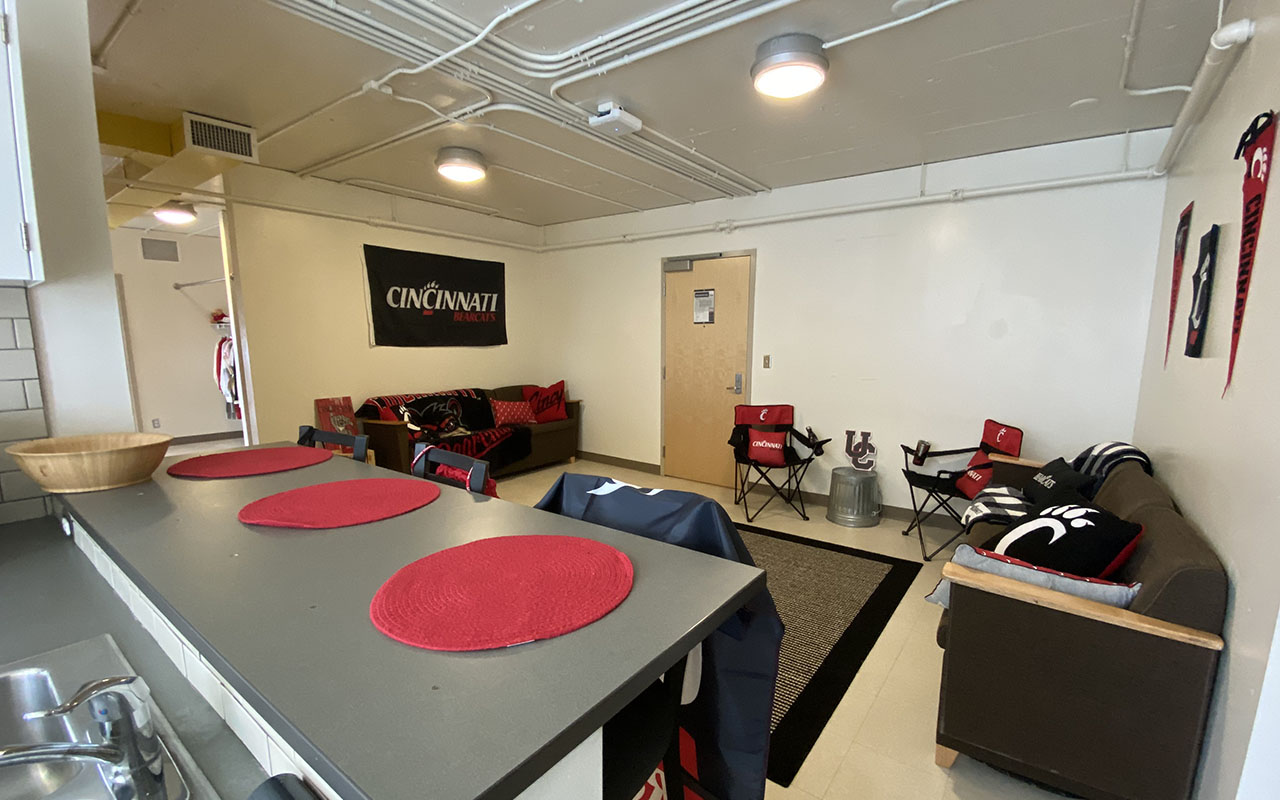 apartment style commons room found in morgens, showing a couches, chairs and a kitchen bar seating area.