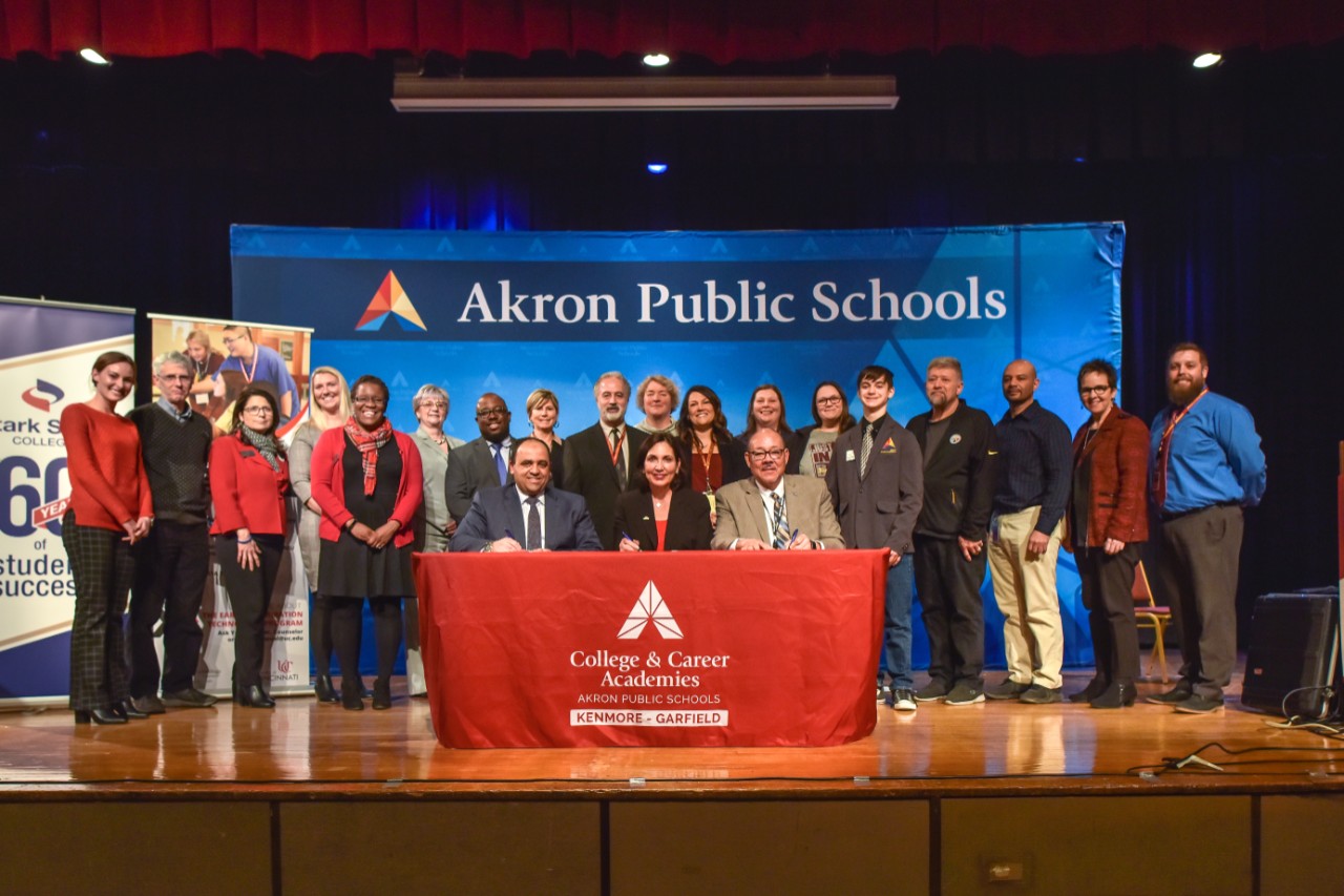 a group of people stand on a stage