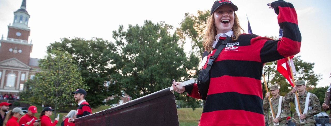 UC student waving in 2022 Homecoming Parade