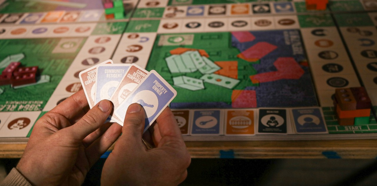 board game with player holding cards