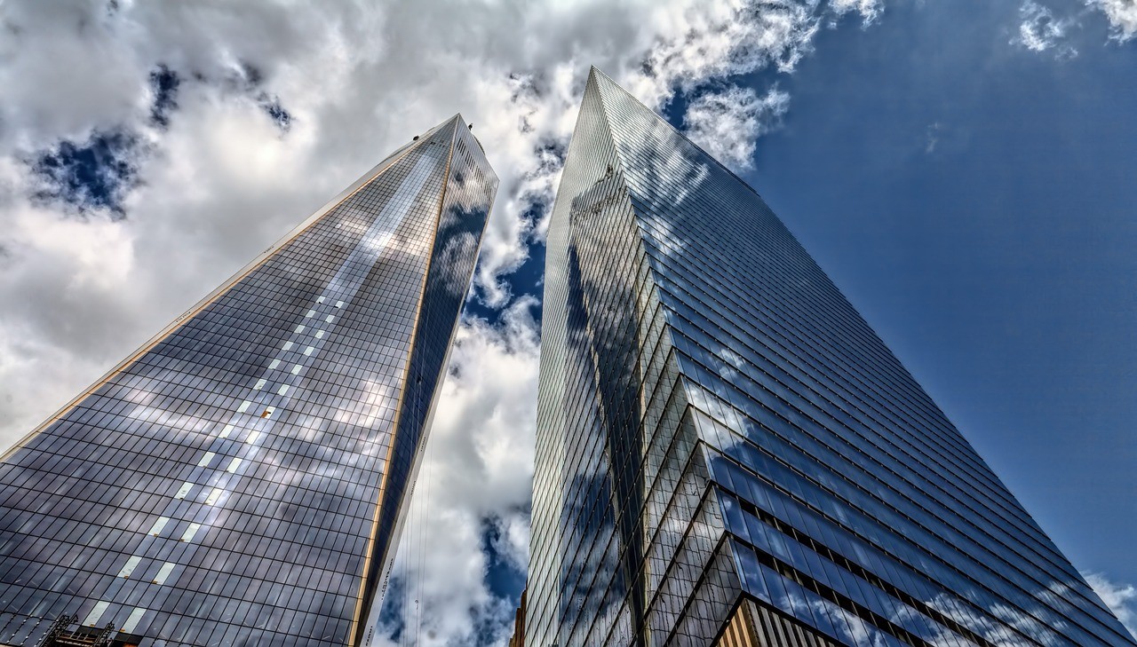 Image of skyscrapers with clouds in the sky.