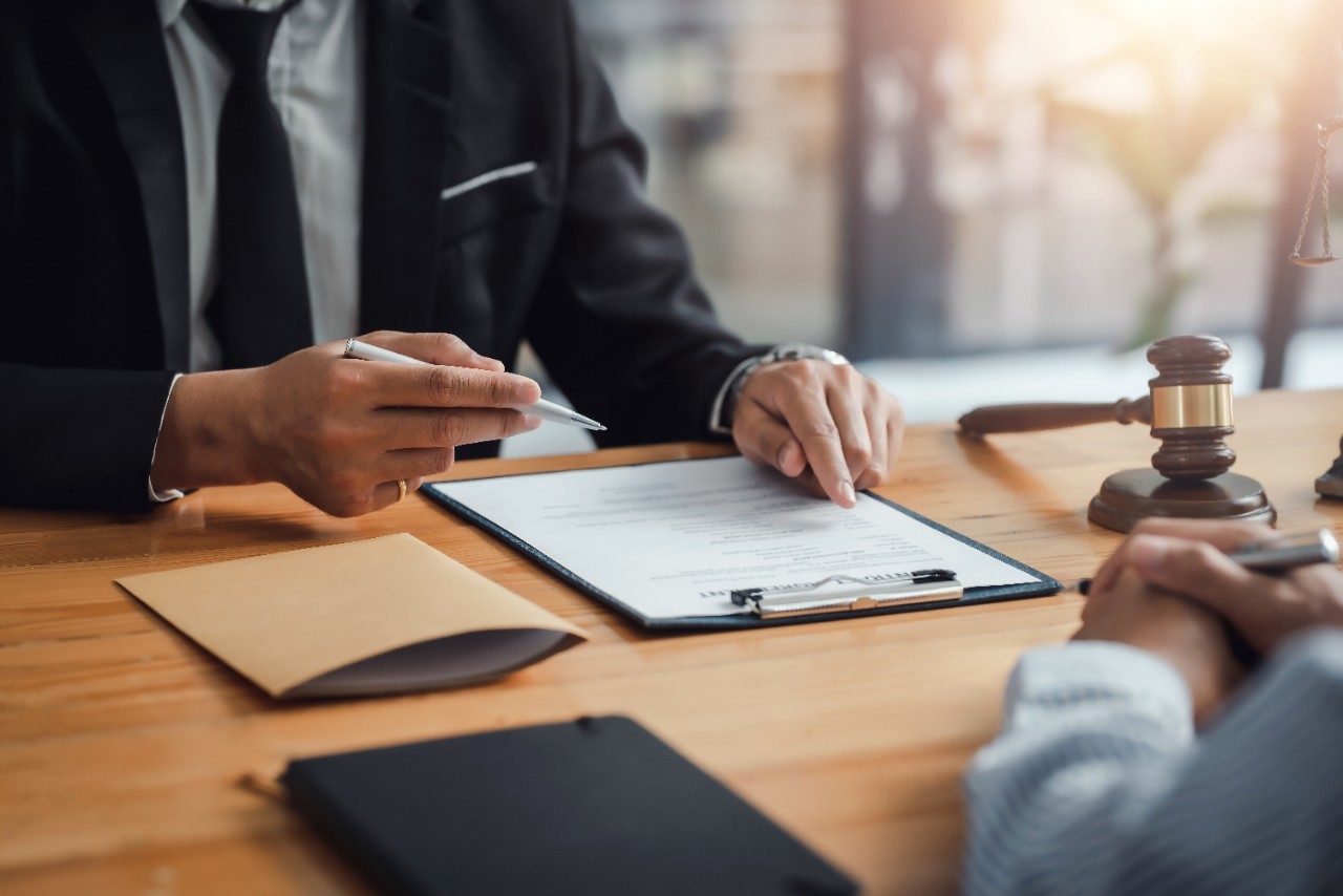 Professional people working at dest from shoulders down, declining a job offer